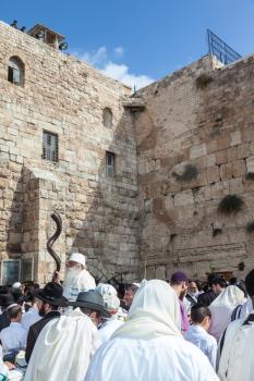JERUSALEM, ISRAEL - OCTOBER 12, 2014: Crowd of faithful Jews wearing prayer shawls. The area in front of Western Wall of  Temple filled with people. Morning autumn Sukkot