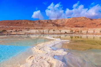 Lowering the water level in the Dead Sea. Evaporated salt out of the water with beautiful patterns