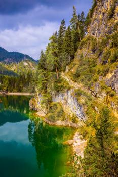 Travel to the Southern Tyrol, Italy. Walk around the Alpine lake Lago di Braies. The concept of environmental and hiking