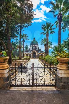 Roman Catholic Church of the Beatitudes.  Stone path leading to the monastery. Openwork metal gate closes the entrance to the basilica