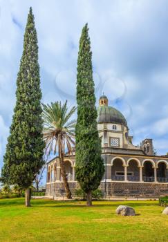Catholic monastery and a small church Mount of Beatitudes. Beautiful park of cypress and palm trees. Israel, the shores of Lake Kinneret