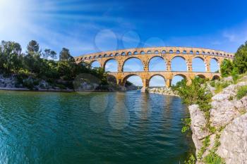  Provence, spring sunny day. Three-tiered aqueduct Pont du Gard - the highest in Europe. The bridge was built in Roman times on the river Gardon