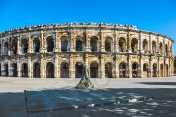  Monument to bullfighter installed before the amphitheater. Roman arena in Nimes, Provence. Photo taken fisheye lens