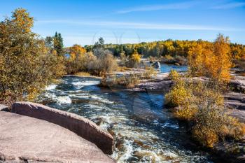  Warm clear autumn day. Foam water rapids on the smooth stones of the Winnipeg River. The concept of ecological tourism