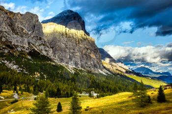 Travel in the Dolomites. To pass Faltsarego approaching snowstorm. The concept of active and adventure tourism