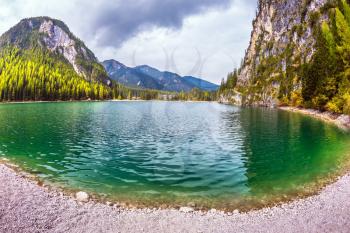 Travel to the Southern Tyrol, Italy. Walk around the Alpine lake Lago di Braies. The concept of hiking. Photo taken fisheye lens