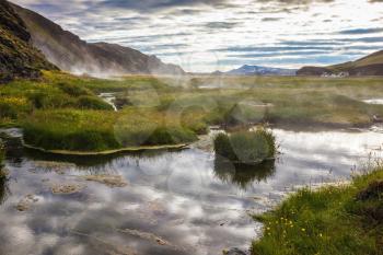 Sunrise Park Landmannalaugar. White nights in Iceland. Hot steam over the source of the thermal waters