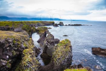 Magical coastal cliffs fishing village Arnastapi. July day in Iceland