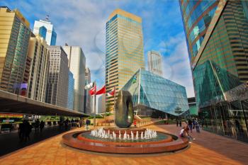 HONG KONG, DECEMBER 11, 2014: Hong Kong Special Administrative Region. The modern city on the ocean coast. Square in downtown decorated with a fountain and an abstract sculpture