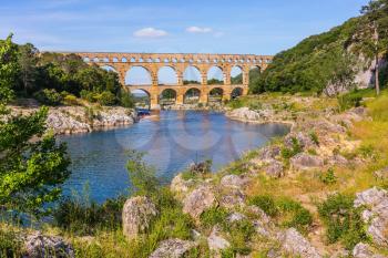 Three-tiered aqueduct Pont du Gard - the highest in Europe.  Provence, spring sunny day. The bridge was built in Roman times on the river Gardon