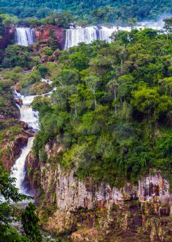Iguazu Falls National Park. Grandiose complex of waterfalls on the border of Argentina, Brazil and Paraguay. Several picturesque waterfalls. The concept of extreme and exotic tourism