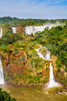 Several picturesque waterfalls. Iguazu Falls National Park - grandiose complex of waterfalls on the border of Argentina, Brazil and Paraguay. The concept of extreme and exotic tourism