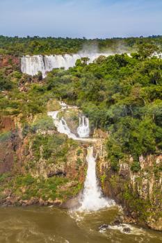  The concept of extreme and exotic tourism. Several picturesque waterfalls. Iguazu Falls National Park - grandiose complex of waterfalls on the border of Argentina, Brazil and Paraguay