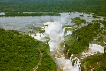 Devil's Throat - largest waterfall of the Iguazu Falls. Iguazu River spreads widely among the dense tropical forests. Picture taken from a helicopter