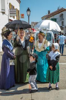 Saint-Marie-de-la-Mer, Provence, France - May 25, 2015. Women and children in fabulously beautiful medieval clothes. The gypsies feast of St. Sara. The concept of ethnographic tourism 