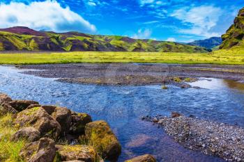  On bottom of canyon many streams flow. Canyon Pakgil in Iceland.  Picturesque basalt hills overgrown green grass and moss
