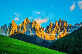 Magnificent serrated cliffs illuminate the summer sunset. The Dolomites. The concept of eco-tourism in Tirol