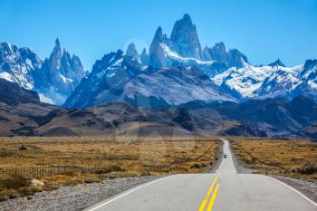  Fine concrete highway to the majestic Mount Fitz Roy. Sunny autumn day in February. Argentine Patagonia