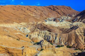 Ancient mountains in the valley of the Dead Sea. Picturesque multi-colored taluses dry sandstone