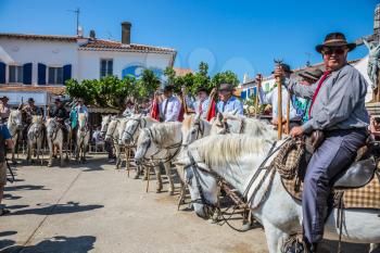 Sent-Mari-de-la-Mer, Provence, France - May 25, 2015.  Convoy - guards on white horses lined up before the start of parade. Square in the center of city. World Festival of Gypsies