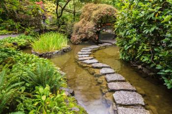 Amazingly beautiful decorative private garden in western Canada Butchart Gardens. The track of the stones in the Japanese part of the garden