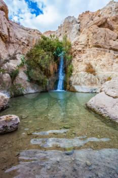 Charming small falls among stones of the dried-up desert.  The journey through the national park and reserves Ein Gedi, Israel
