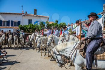 Sent-Mari-de-la-Mer, Provence, France - May 25, 2015. Guards on white horses before the start of the parade. World Festival of Gypsies. The concept of ethnographic and active tourism