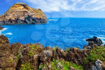 Picturesque rocks and stones  at coast of Atlantic. Magic travel on the volcanic island of Madeira. Concept of exotic and ecological tourism