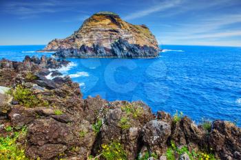 Magic travel on the fantastic island of Madeira. Rocks and stones  at coast of Atlantic. Concept of exotic and ecological tourism