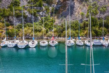  White and graceful sailing yachts in turquoise water of the gulf. Small fjords in Calanque National Park between Marseille and Cassis
