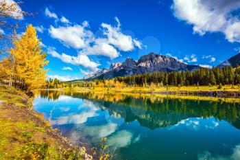  Canmore, near Banff National Park. The concept of hiking. The path and yellowing aspens surround the lake