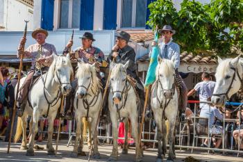 Sent-Mari-de-la-Mer, Provence, France - May 25, 2015. Guards on white horses before the start of the parade. The concept of active and ethnographic tourism. World Festival of Gypsies