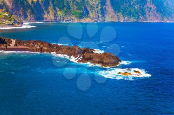 Rocks at coast of Atlantic. Beautiful coast of Madeira. The concept of exotic and ecological tourism