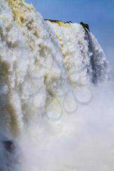 Water splashes and fog over Iguazu Falls on the border of Brazil, Argentina and Paraguay. Concept of active and extreme tourism