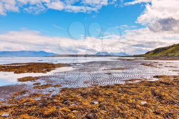 Iceland in the summer. The picturesque bay of Hoonah during low tide at sunset