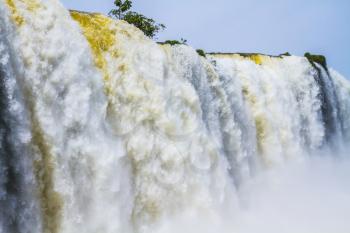 Rumbling world of falling water. Iguazu Falls in South America, on the border of three countries. Concept of active and extreme tourism