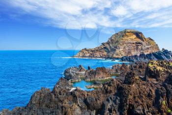 Magic travel on the fantastic island of Madeira. Rocks, bays and grottoes at coast of Atlantic. Concept of exotic and ecological tourism