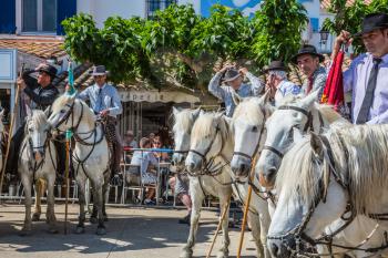 Sent-Mari-de-la-Mer, Provence, France - May 25, 2015. Convoy - guards on white horses before the start of the parade. World Festival of Gypsies. The concept of ethnographic tourism