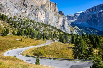 Picturesque road through the Sella Pass, Dolomites. Majestic ridge of dolomite rocks. The concept of extreme and ecological tourism