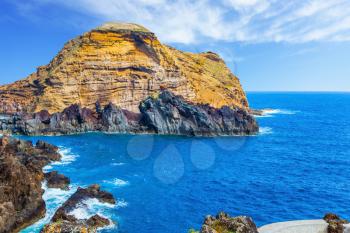Rocks and bays at coast of Atlantic. Fantastically beautiful coast of Madeira. The concept of exotic and ecological tourism