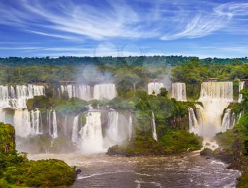 Grandiose waterfalls Iguazu in South America, on the border of three countries: Brazil, Argentina and Paraguay. Concept of active and extreme tourism