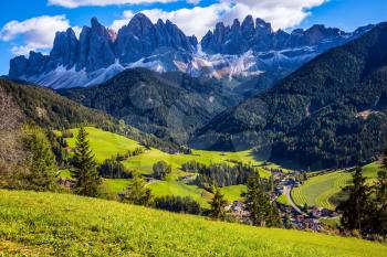 Dolomites, Val de Funes valley. Lovely  day in Naturpark Puez-Odle. Odle mountain peaks around the green alpine meadows of the valley