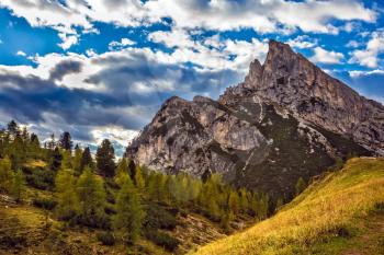 Travel in the Dolomites. To pass Faltsarego approaching snowstorm. Concept of active and extreme tourism