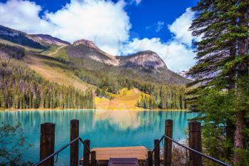 Magic Emerald Lake in Yoho National Park, Rocky Mountains. The descent to the water on the lake promenade. The concept of eco-tourism 