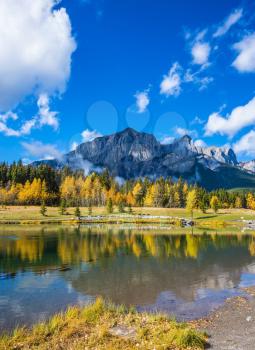Canmore, near Banff National Park. The concept of recreational tourism. Majestic mountains and scenic cumulus clouds are reflected in the water