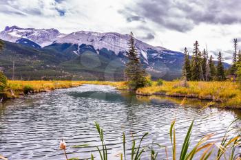 The wind creates a ripple on the lake water. Magnificent journey through the Rocky Mountains of Canada. Concept of active and ecological tourism