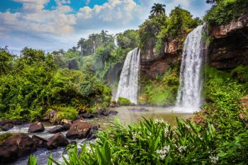 Two rapid powerful waterfalls from the Iguazu Falls in Argentina. The concept of extreme and ecological tourism. Picturesque ledges form the famous waterfalls