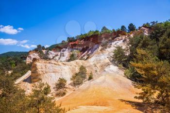 Reserve in mining ocher quarry. Orange and red picturesque hills. Languedoc - Roussillon, Provence, France