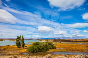 Patagonian Pampas. Flat plain with shallow lakes and yellowed grass. Concept of active and exotic tourism