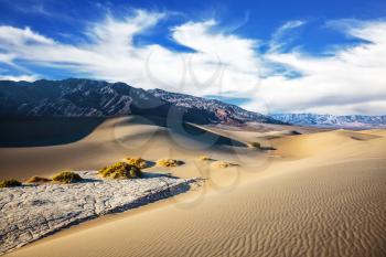 Hot and windy morning in the desert. Gentle ripples on sand dunes. Hot autumn in Death Valley, California